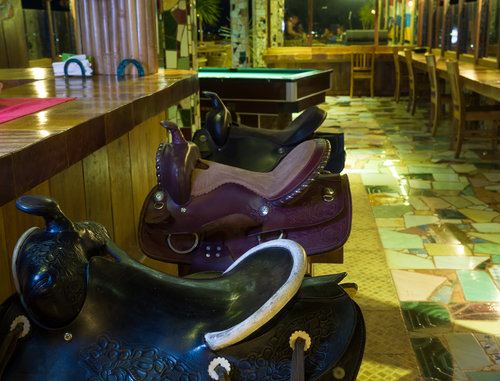 Hotel La Hasienda, Kupang, NTT, Indonesia. Detail from the restaurant, horse saddle bar stools.&nbsp; Photo © Basil Rolandsen (http://media.bouvet.org)